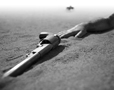 Black and white fictional photograph of Cisco's Arm and Hand lying in the sand, photography by Tony Sanders